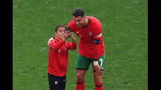 Ronaldo takes selfie with pitch intruder during Portugal vs Turkey Euro 2024 match.