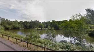 Police have arrested two individuals in connection with the discovery of a man's body in a lake at a holiday park.