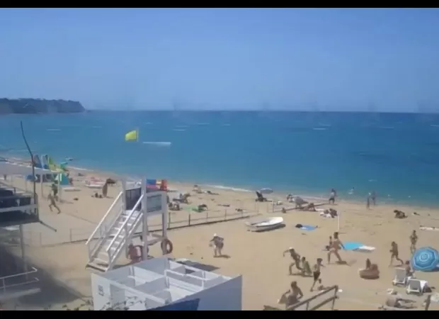 Tourists from Russia run for safety as missiles strike a crowded beach in the Crimean peninsula.