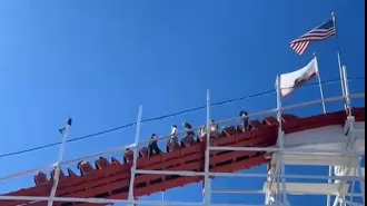 Riders had to climb down roller coaster as they reached the top during evacuation.