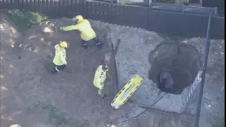 Man saved from Perth backyard hole after hours of being stuck in dramatic rescue attempt.