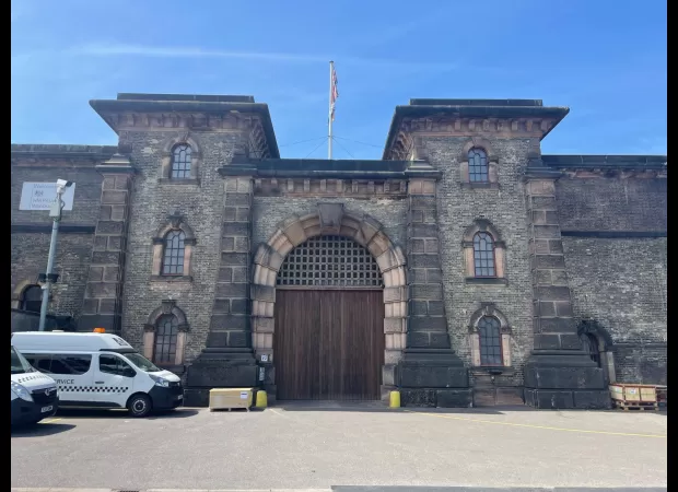 A woman has been arrested for sharing a video of a guard at HMP Wandsworth engaging in sexual activity with an inmate.