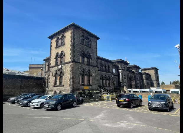 Woman accused of recording video which allegedly depicts a prison officer engaging in sexual activity with an inmate in a cell.