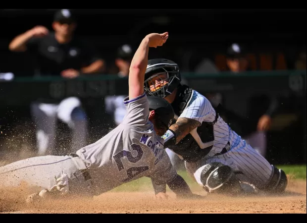 The Rockies' strong defense leads them to a victory against the White Sox after a lengthy 14-inning game.