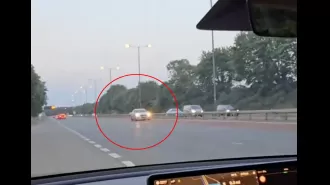 A reckless Audi driver races in the wrong direction on a highway.