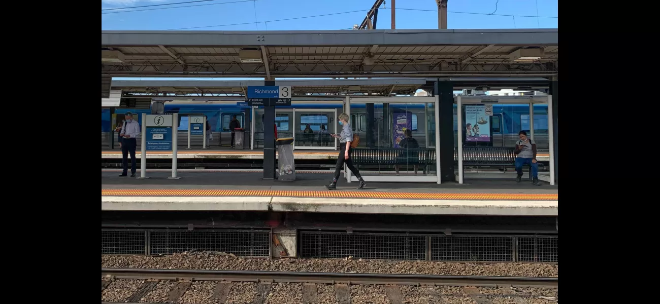 A woman was pushed onto Melbourne train tracks by a stranger and is now in the hospital.