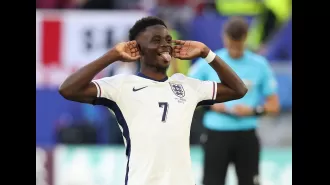 Sancho congratulates Saka after England's win against Switzerland in Euro 2024.