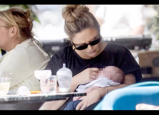 Mom Emily Atack spotted with newborn for first time since delivery, showing her love and care.