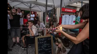 Tourists in Barcelona are being targeted with water by protesters, but the reason for this action is unclear.