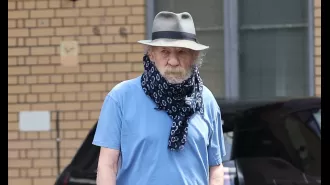 Actor Ian McKellen wears scarf to conceal neck brace following fall from west end stage.