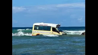 Rising tides sweep ice cream truck into ocean.