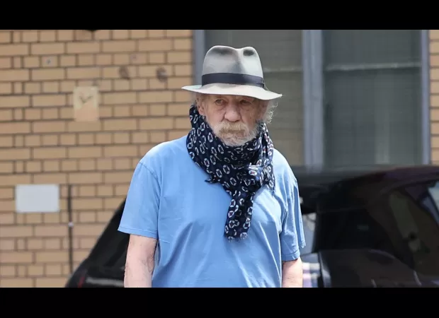 Actor Ian McKellen wears scarf to conceal neck brace following fall from west end stage.