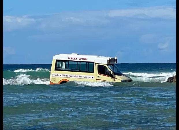 Rising tides sweep ice cream truck into ocean.