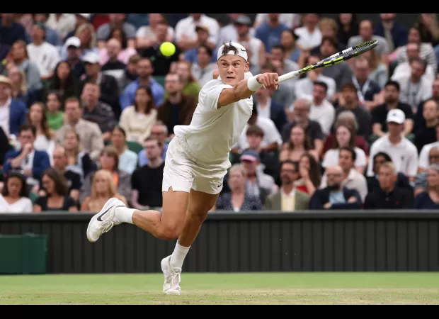 Holger Rune accidentally hits a ball boy during a match against Novak Djokovic at Wimbledon.