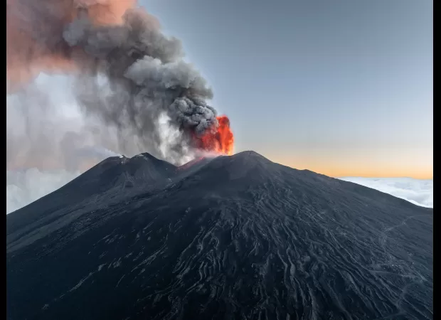 Travel chaos caused by eruption of Mount Etna prompts red alert.
