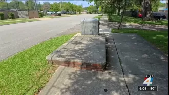 Strange tale of a grave nestled in a sidewalk where children frolic.