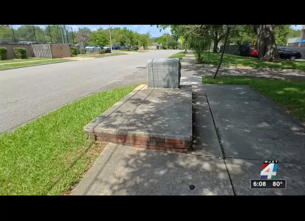 Strange tale of a grave nestled in a sidewalk where children frolic.