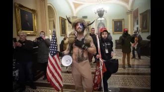 'QAnon Shaman' seeks return of iconic helmet and spear from Capitol incident.