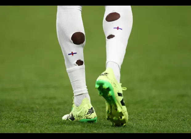 Why do English soccer players make holes in their socks?