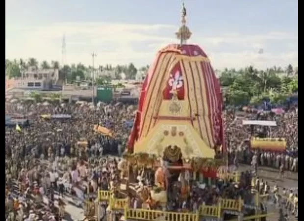 Crowds of people in Puri participate in the annual car festival, pulling chariots to welcome Lord Jagannath's return.