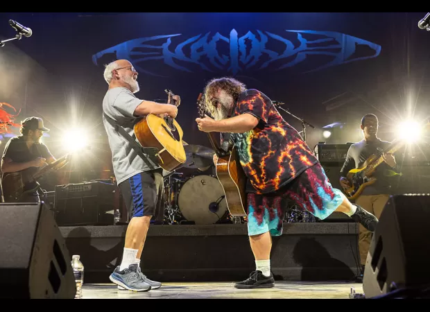 Famous American rock group delays performance at the last minute due to controversy surrounding a comment about shooting Donald Trump.