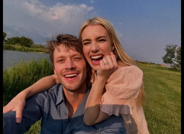 Actress Emma Roberts shows off a big diamond ring while revealing she is engaged to Cody John.