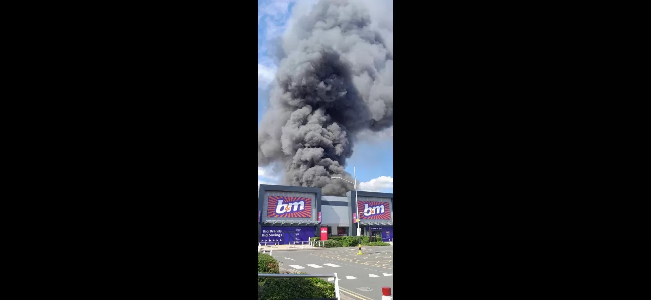 A massive fire at a factory, with smoke seen from 15 miles away.