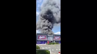 A massive fire at a factory, with smoke seen from 15 miles away.