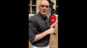 Hank Azaria can't make royal guard smile despite his best efforts.