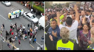 Police car flips during 'disturbance' in busy streets.