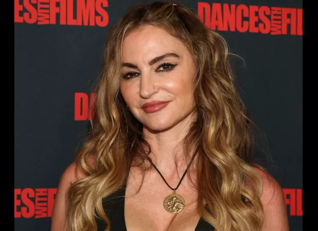 Former 90s TV star's 13-year-old son helps edit her provocative photos for OnlyFans.