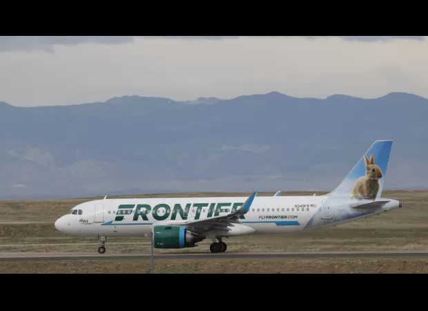 Denver International Airport experiences flight cancellations and delays due to an outage at Frontier Airlines.