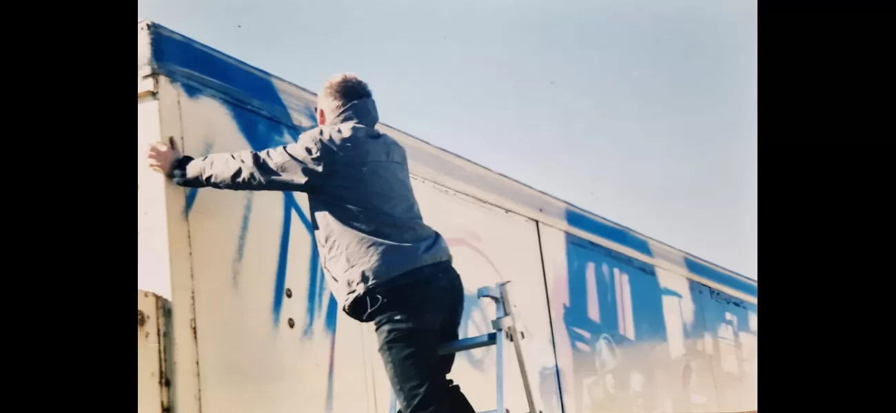 Rare images of Banksy captured during his early days as a street artist, painting a mural before he gained worldwide recognition.