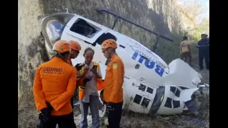 A helicopter crashes in Bali, but five people, including two Australians, manage to survive.