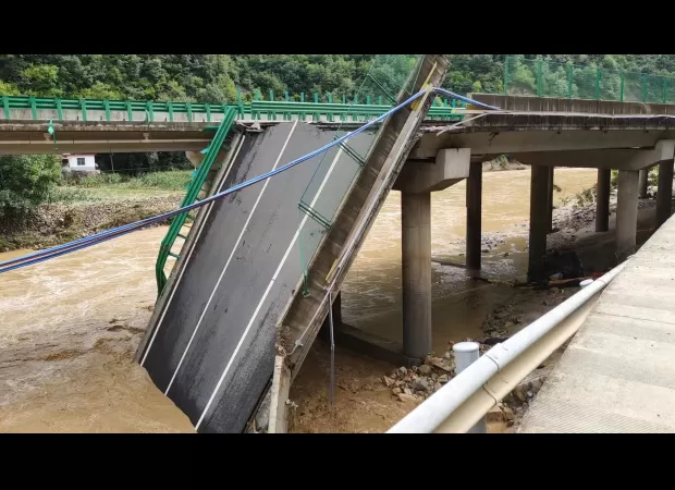 Flooding causes bridge collapse, leaving 11 dead and many missing.