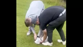 Group of men free seagull caught in net on golf course and give it food from Greggs.
