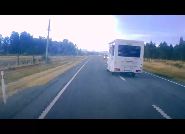 Video captures near-crash between campervan and car on dangerous New Zealand road using dashcam footage.