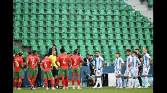 Fans removed from stadium during chaotic Olympics football game due to field intrusion.