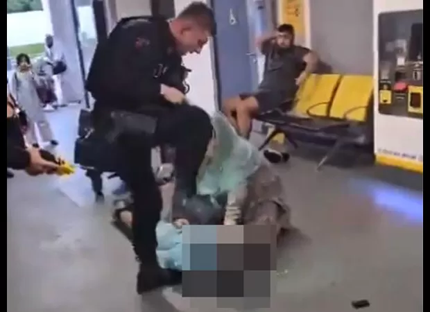 Police officer viciously attacks boy, brutally kicking him in face and stomping on his head as he lies defenseless on the ground.