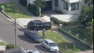 Two people fought police officers after reportedly being discovered with firearms on a street in Sydney.
