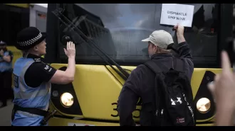 Protesters obstruct Manchester tram lines after police officer assaulted man.