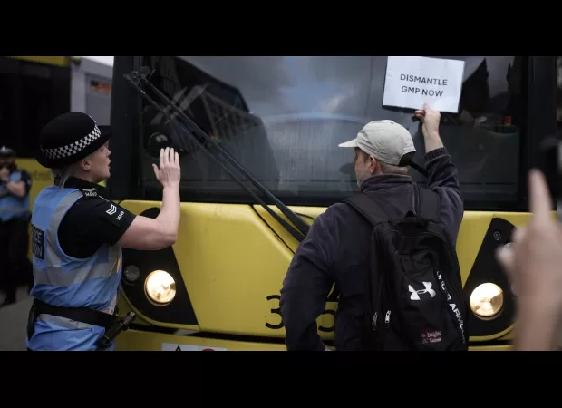 Protesters obstruct Manchester tram lines after police officer assaulted man.
