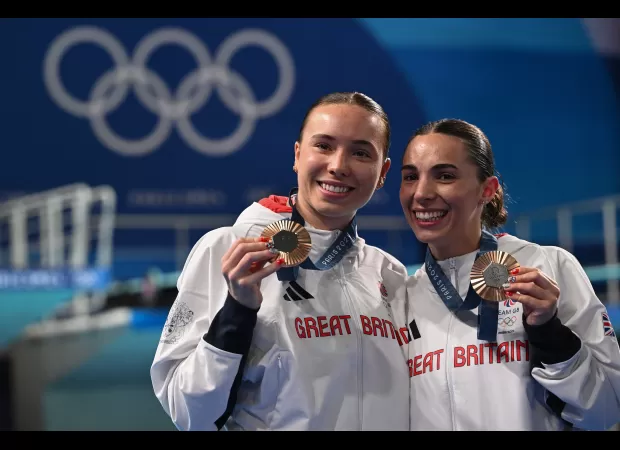 Two athletes honor their deceased coach after winning Olympic bronze.