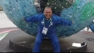 A 60-year-old boxing coach has died of a heart attack while staying in the Olympic village.