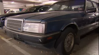 An unknown car has been left at a shopping center for more than ten years, with no explanation.