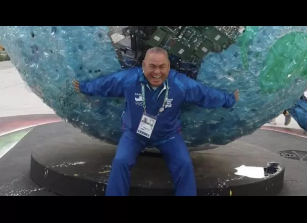 A 60-year-old boxing coach has died of a heart attack while staying in the Olympic village.