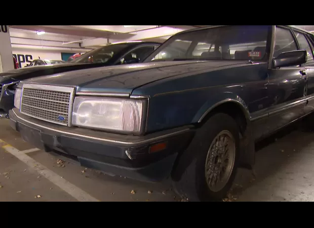 An unknown car has been left at a shopping center for more than ten years, with no explanation.