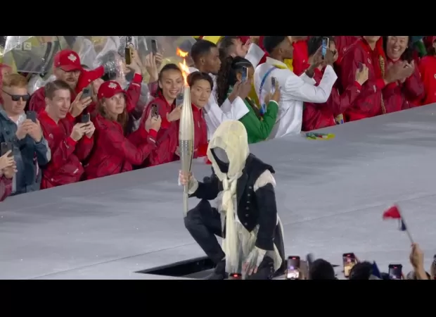 The identity of the mystery Olympic torchbearer, who wore a mask during the relay, was revealed in an Instagram post that has since been deleted.