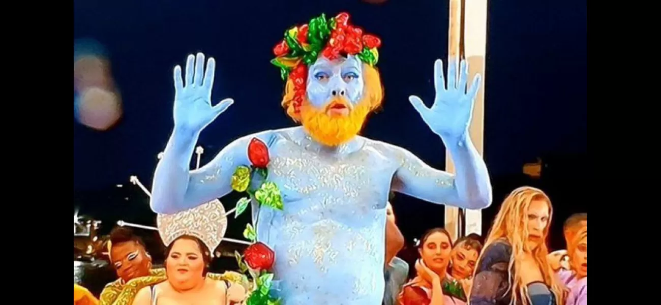 A man painted blue at the Olympics opening ceremony defends himself against criticism and says he endured pain to perform.