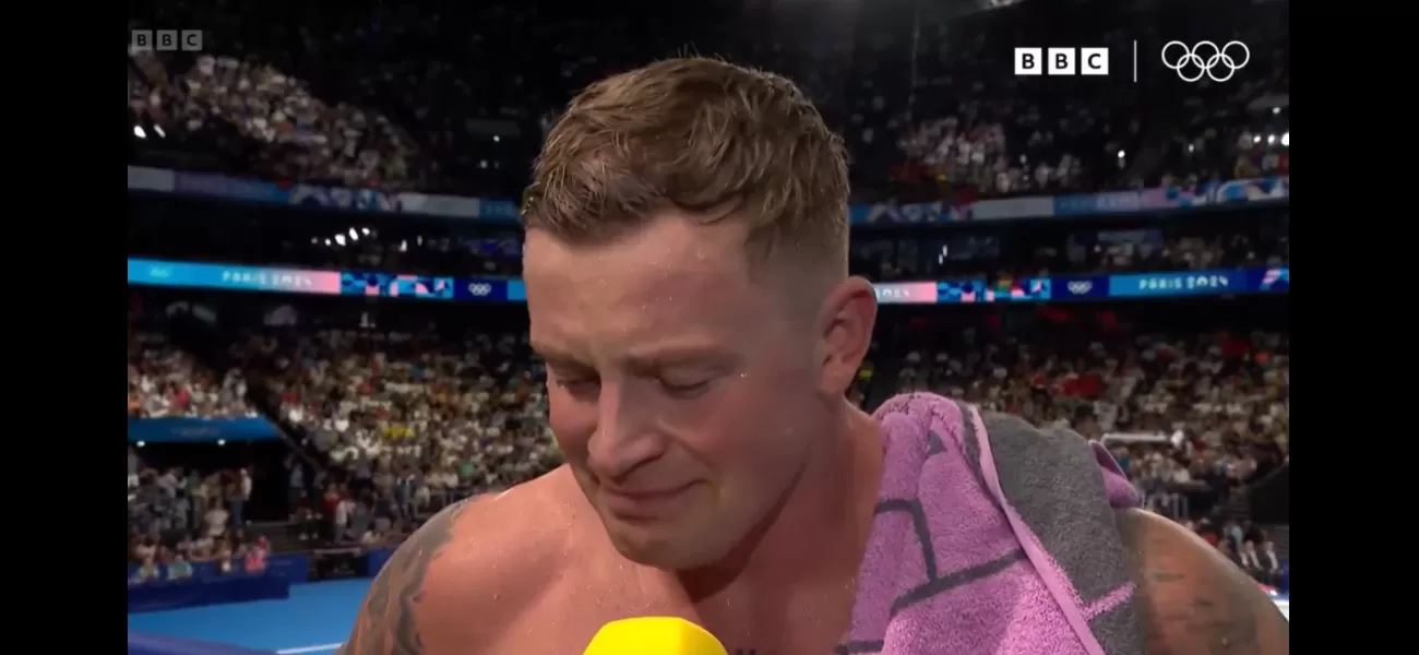BBC reporter comforts Adam Peaty after he falls short of Olympic gold by 0.02 seconds in Team GB's race.